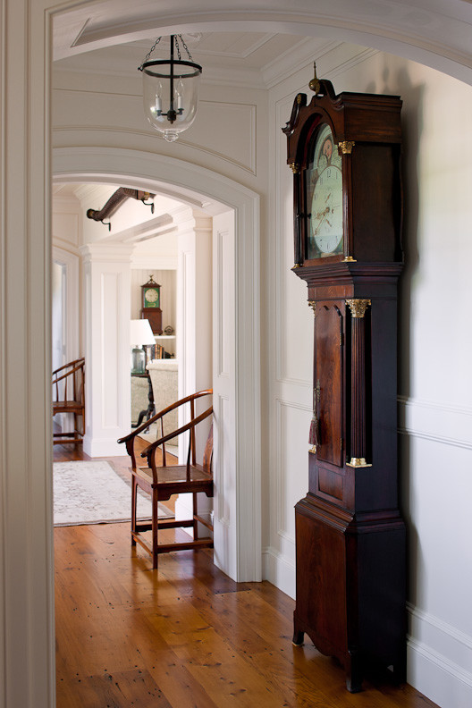This is an example of a large traditional hallway in Boston with white walls and medium hardwood floors.