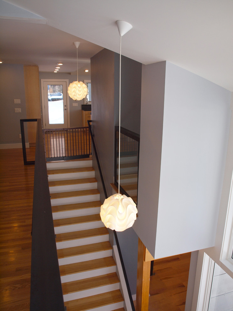 Design ideas for a mid-sized midcentury wood straight staircase in Boston with wood risers.