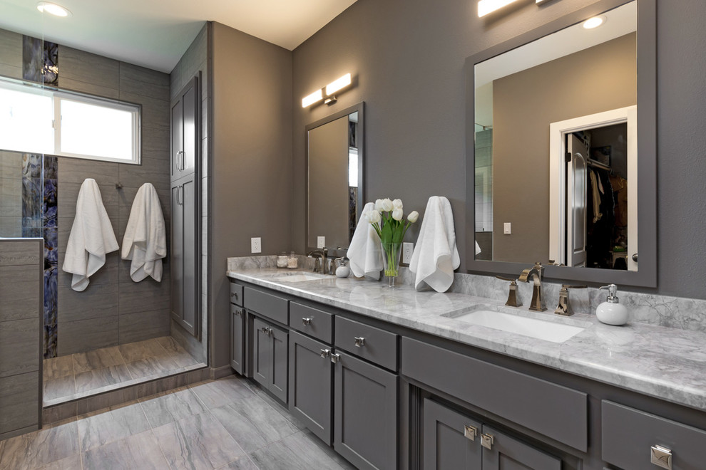 This is an example of a large modern master bathroom in San Francisco with grey cabinets, a double shower, blue tile, gray tile, porcelain tile, grey walls, porcelain floors, an undermount sink, marble benchtops, brown floor, an open shower and grey benchtops.