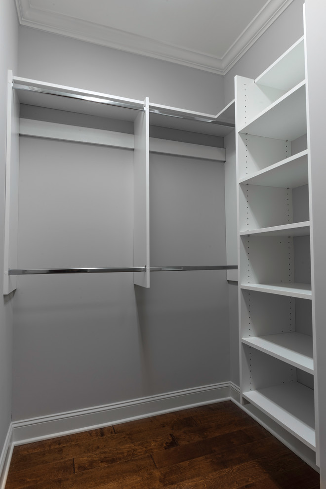 Example of a mid-sized transitional gender-neutral medium tone wood floor walk-in closet design with open cabinets and white cabinets