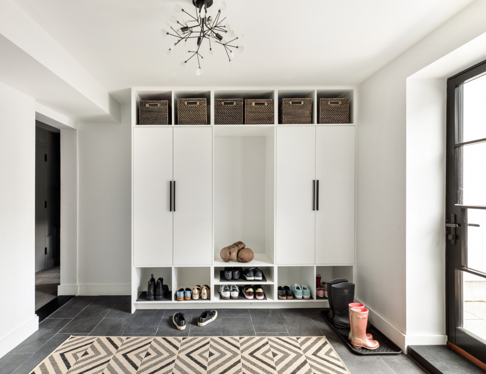 Mid-sized trendy walk-out gray floor and porcelain tile entryway photo in New York with white walls