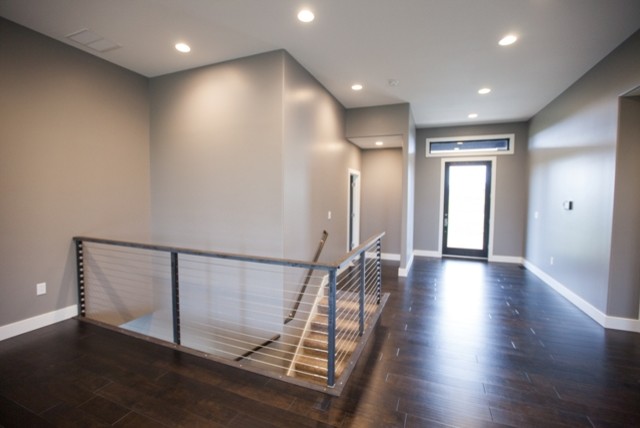 Inspiration for a large modern vinyl floor entry hall remodel with gray walls and a glass front door