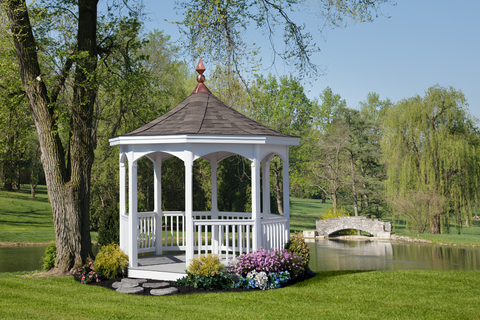 Traditional patio in Other with a gazebo/cabana and a water feature.