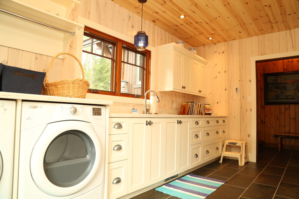 Mid-sized arts and crafts galley utility room in Toronto with an undermount sink, shaker cabinets, white cabinets and a side-by-side washer and dryer.
