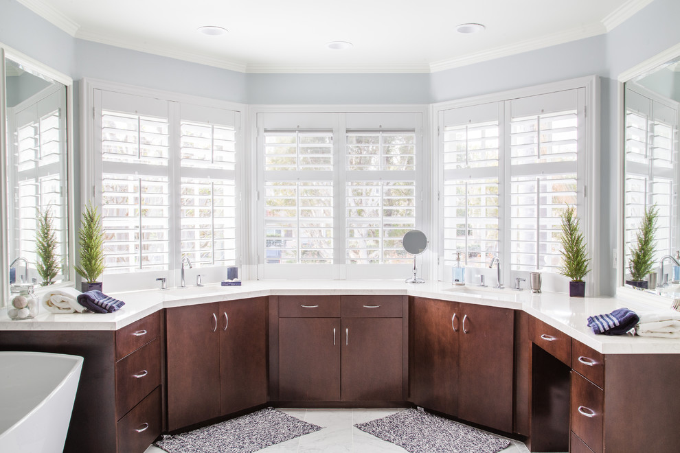 Transitional master gray floor freestanding bathtub photo in Orange County with flat-panel cabinets, dark wood cabinets, gray walls, an undermount sink and white countertops