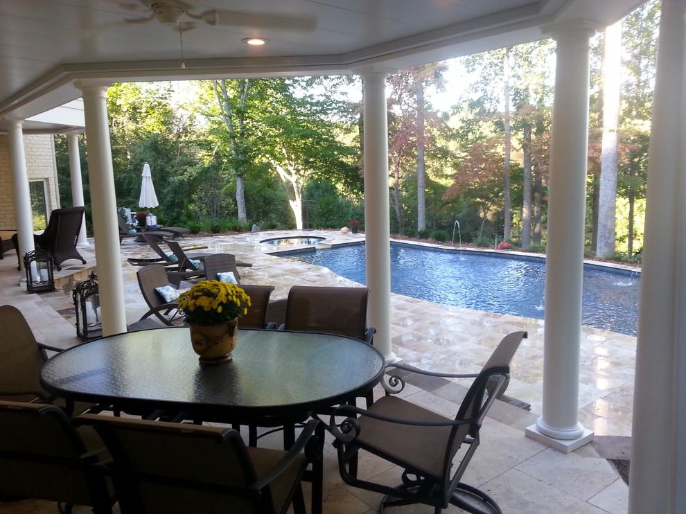 Mid-sized transitional backyard rectangular lap pool in Charlotte with natural stone pavers and a hot tub.