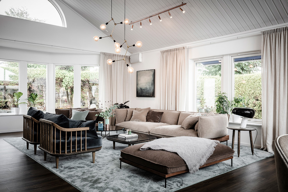 Large scandinavian formal open concept living room in Gothenburg with white walls, dark hardwood floors and brown floor.