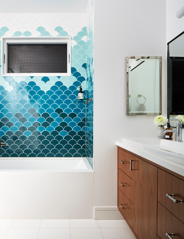 Inspiration for a large transitional 3/4 bathroom in San Francisco with flat-panel cabinets, medium wood cabinets, an alcove tub, blue tile, white walls, a drop-in sink, white floor, white benchtops, a single vanity and a floating vanity.