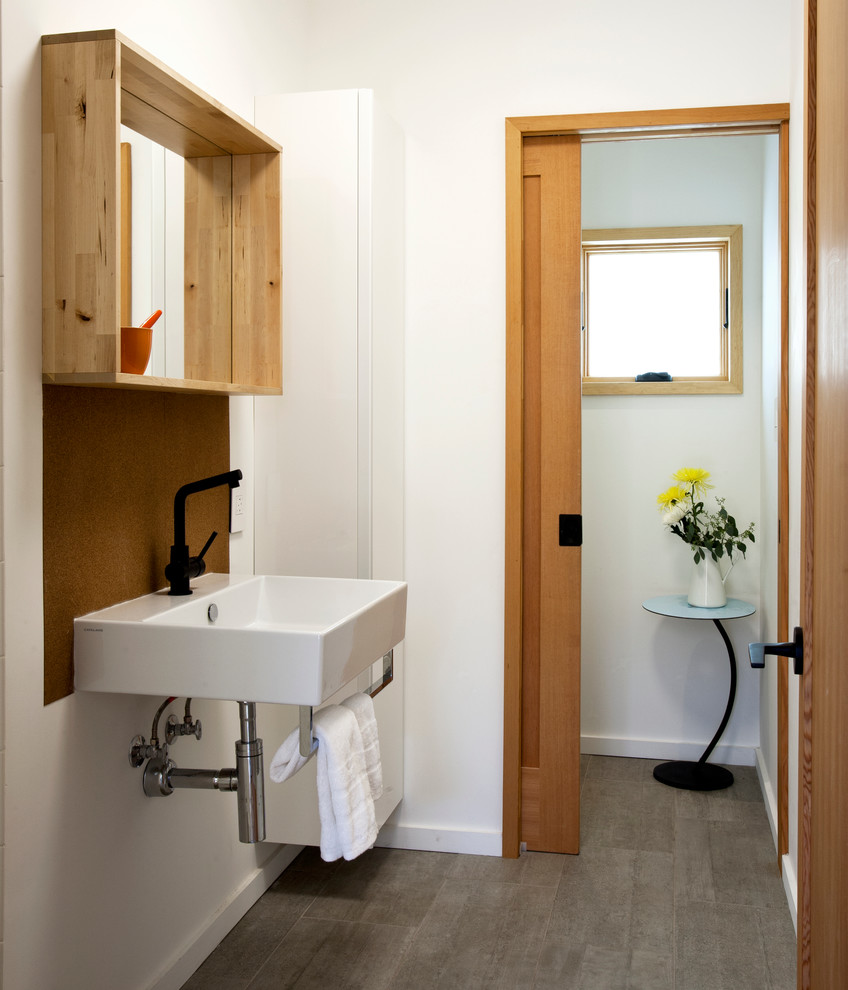 Photo of a contemporary bathroom in San Francisco with a wall-mount sink and white walls.