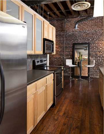 Inspiration for a galley dark wood floor kitchen remodel in Birmingham with stainless steel appliances