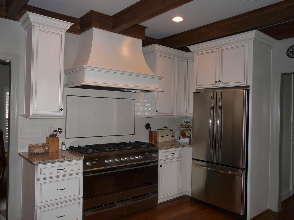 Transitional eat-in kitchen photo in Birmingham with a farmhouse sink, flat-panel cabinets, granite countertops, porcelain backsplash and stainless steel appliances