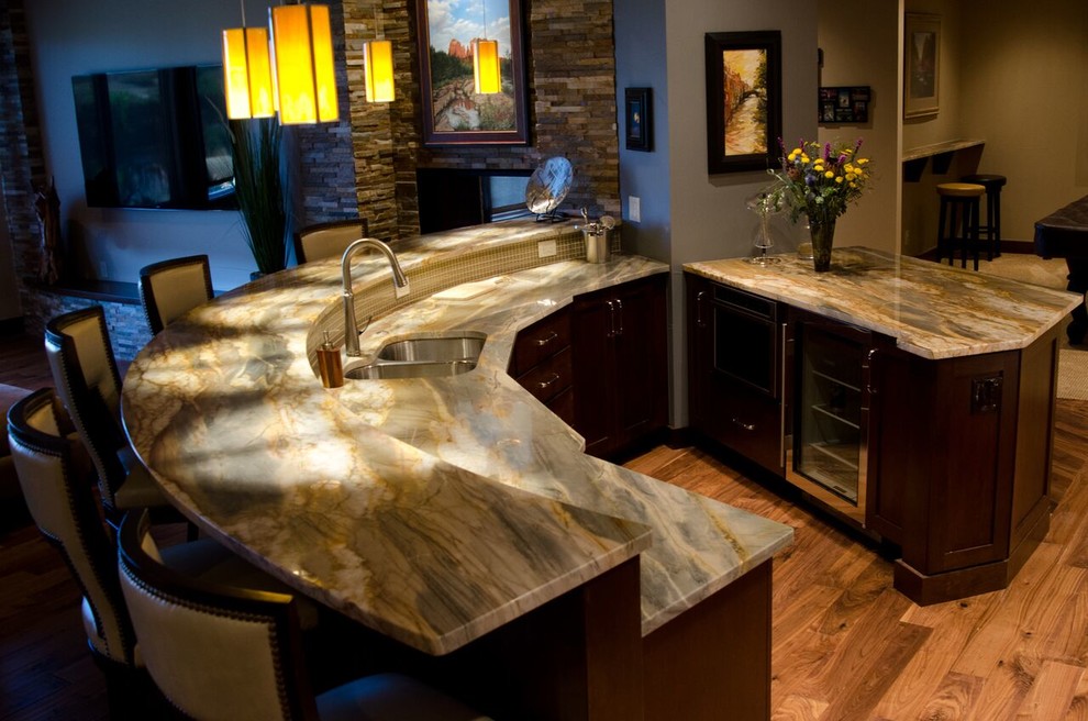 Design ideas for a mid-sized contemporary home bar in Denver with an undermount sink, shaker cabinets, dark wood cabinets, onyx benchtops and medium hardwood floors.