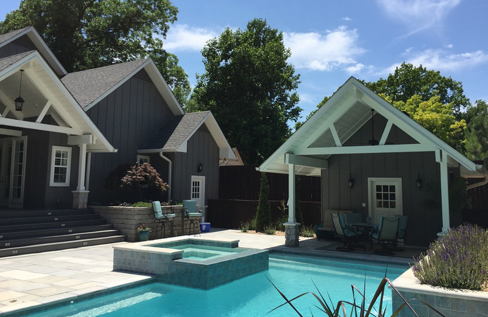 Example of a large transitional backyard concrete paver and rectangular hot tub design