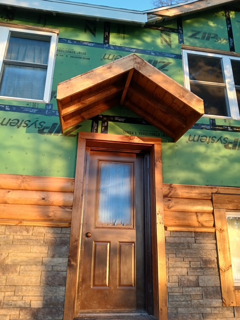 Log Siding, Stamped Concrete and Post and Beam Carport