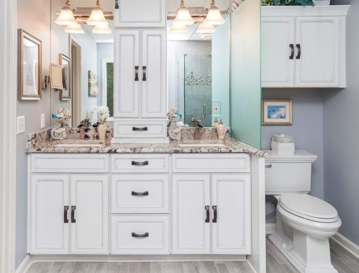 Design ideas for a small beach style master bathroom in Atlanta with recessed-panel cabinets, a drop-in tub, blue walls, porcelain floors, an undermount sink, granite benchtops and grey floor.