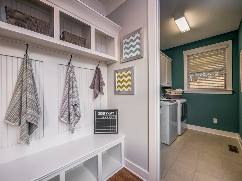Photo of a mid-sized galley utility room in Charlotte with an utility sink, open cabinets, white cabinets, ceramic floors, beige floor and planked wall panelling.