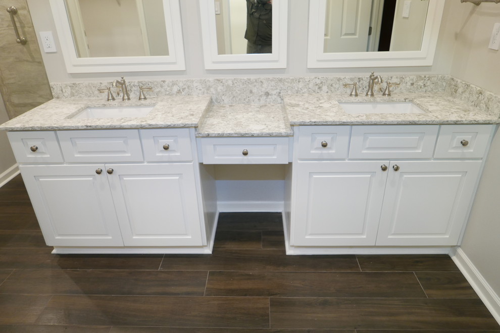 Inspiration for a large traditional master bathroom in Other with raised-panel cabinets, white cabinets, an undermount tub, a corner shower, a bidet, gray tile, porcelain tile, grey walls, porcelain floors, an undermount sink, engineered quartz benchtops, brown floor, a hinged shower door and multi-coloured benchtops.