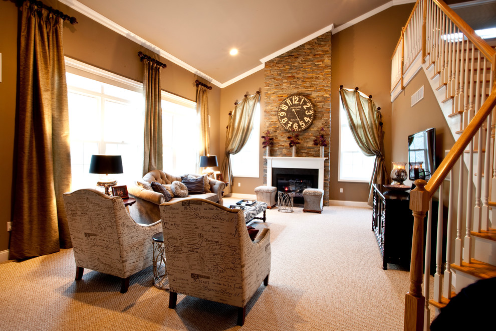 Photo of a large transitional open concept living room in New York with beige walls, carpet, a standard fireplace, a stone fireplace surround and a wall-mounted tv.