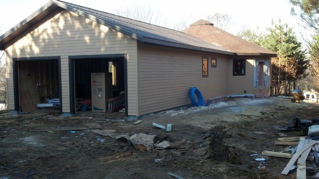 Mid-sized arts and crafts one-story concrete fiberboard exterior home photo in Other