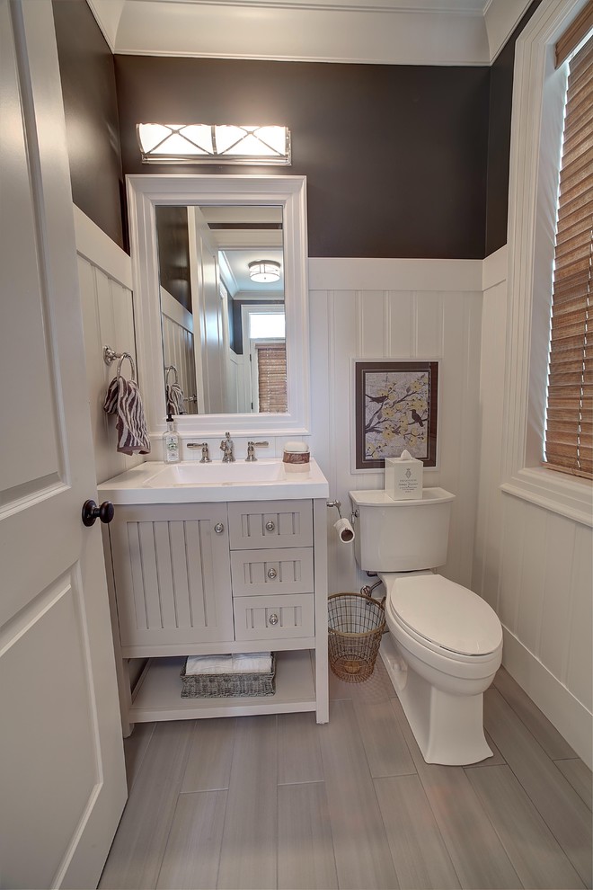 Mid-sized contemporary powder room in Detroit with furniture-like cabinets, beige cabinets, a two-piece toilet, ceramic floors and an integrated sink.