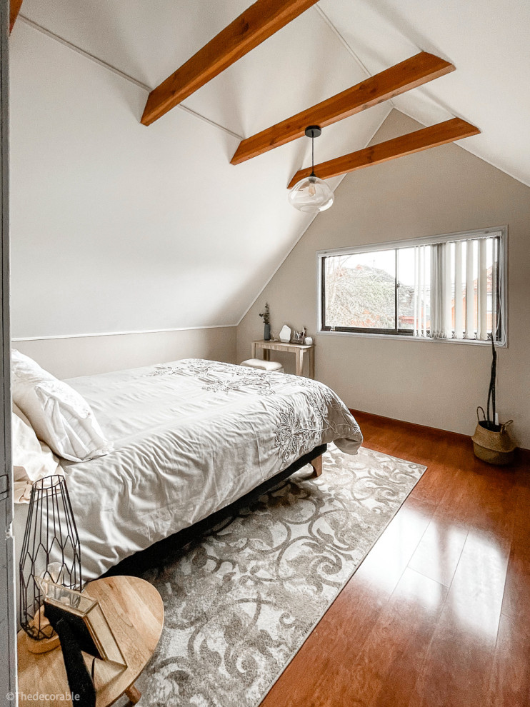 Imagen de dormitorio principal y beige y blanco de estilo zen grande con paredes beige, suelo laminado, suelo marrón, techo inclinado y papel pintado
