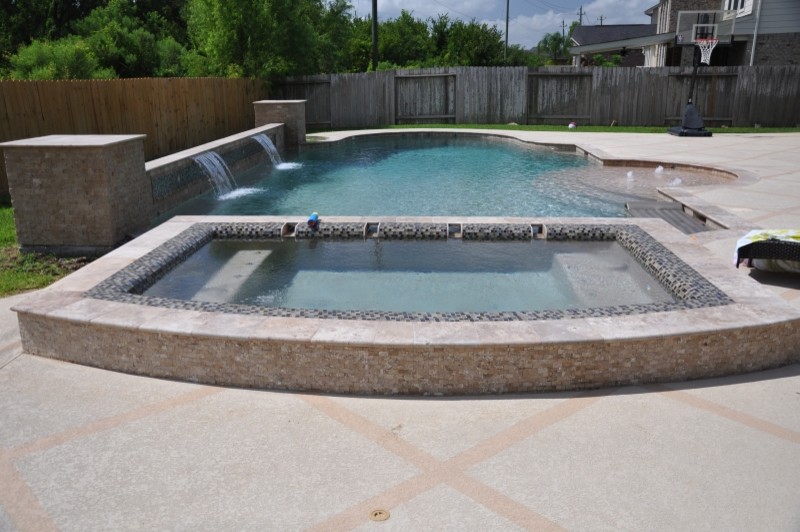 Inspiration for a large transitional backyard stamped concrete and custom-shaped hot tub remodel in Houston