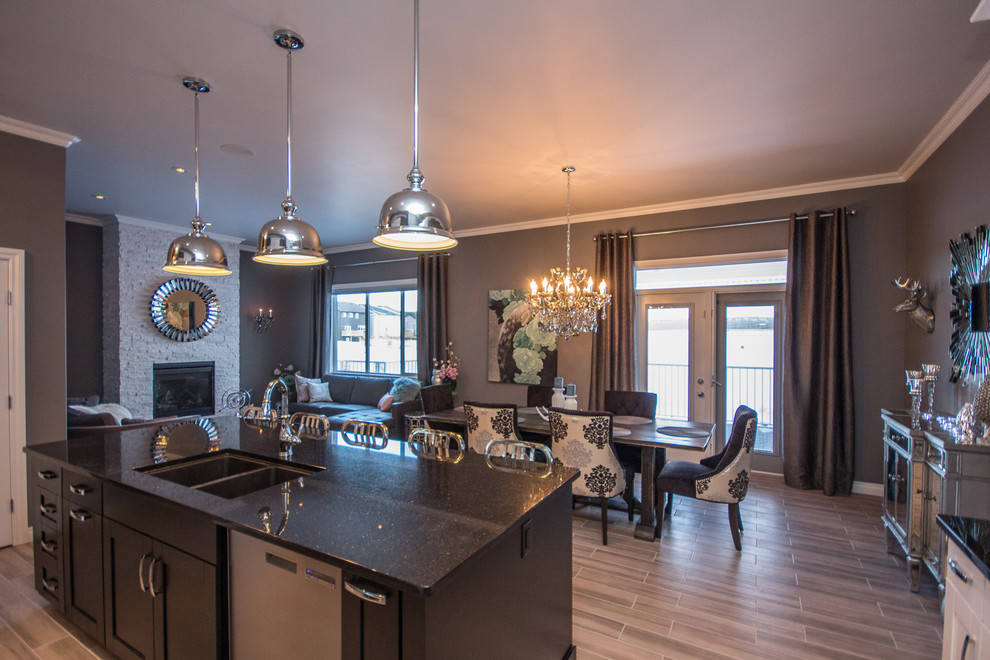 Example of a mid-sized transitional l-shaped porcelain tile eat-in kitchen design in Calgary with a double-bowl sink, shaker cabinets, white cabinets, multicolored backsplash, mosaic tile backsplash, stainless steel appliances, an island and quartz countertops