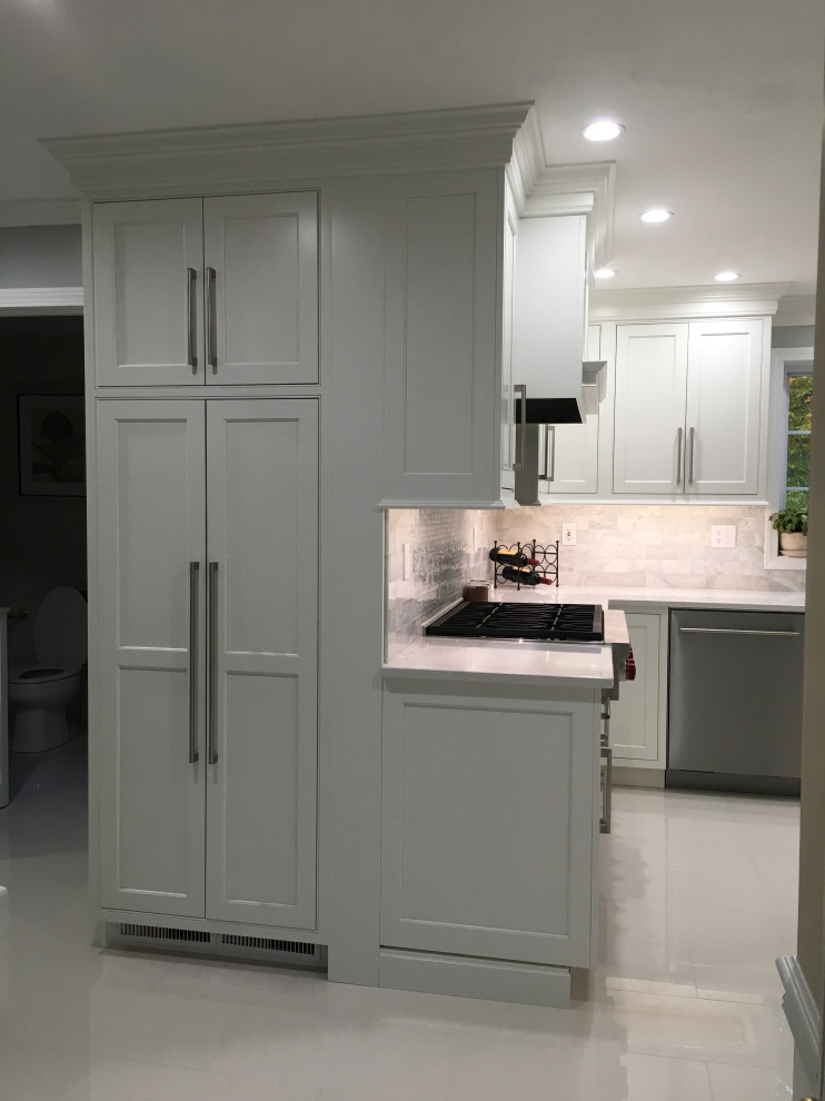 This is an example of a large modern l-shaped eat-in kitchen in Other with an undermount sink, beaded inset cabinets, white cabinets, quartz benchtops, white splashback, stainless steel appliances, with island, white floor and white benchtop.