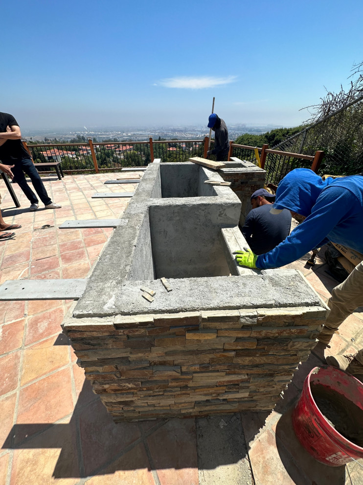 Medium sized traditional back l-shaped natural swimming pool in Los Angeles with with pool landscaping.