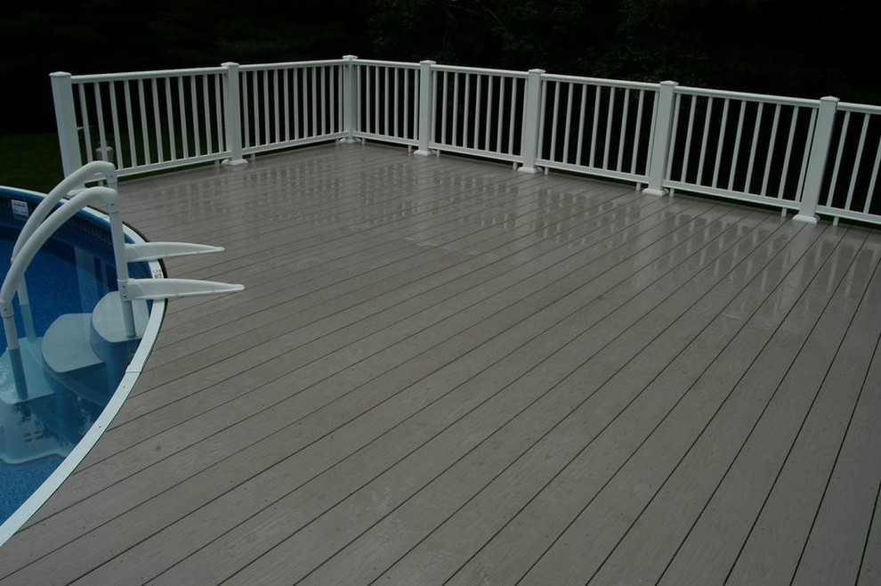 Photo of a large traditional backyard deck in Boston with a water feature and no cover.