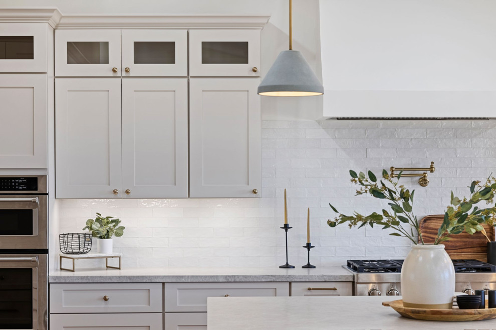 Large transitional u-shaped eat-in kitchen photo in Phoenix with shaker cabinets, gray cabinets, white backsplash, stainless steel appliances and an island