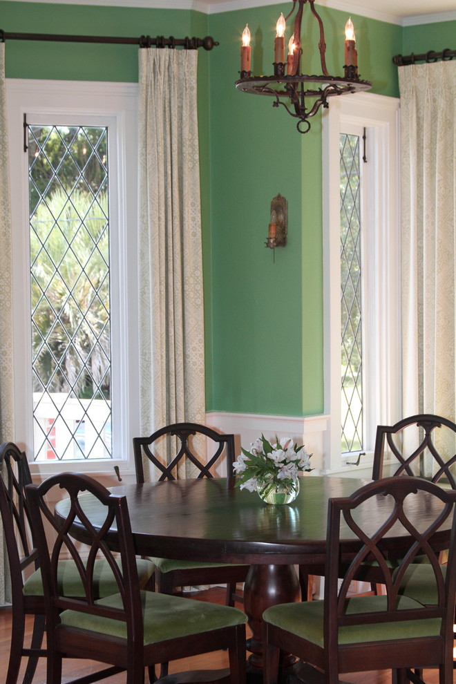 Inspiration for a mid-sized arts and crafts separate dining room in Orlando with green walls, medium hardwood floors and no fireplace.