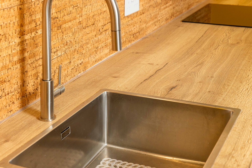 Design ideas for an expansive industrial kitchen/dining room in Kent with brown walls, concrete flooring, grey floors and feature lighting.