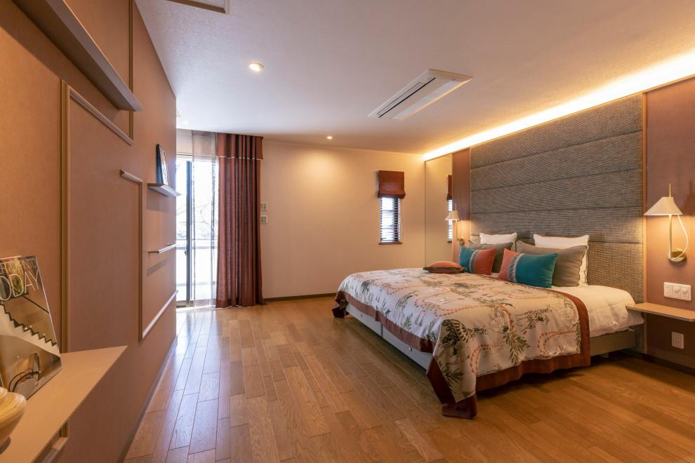 This is an example of a large contemporary master bedroom in Other with brown walls, light hardwood flooring, orange floors, a wallpapered ceiling and wallpapered walls.