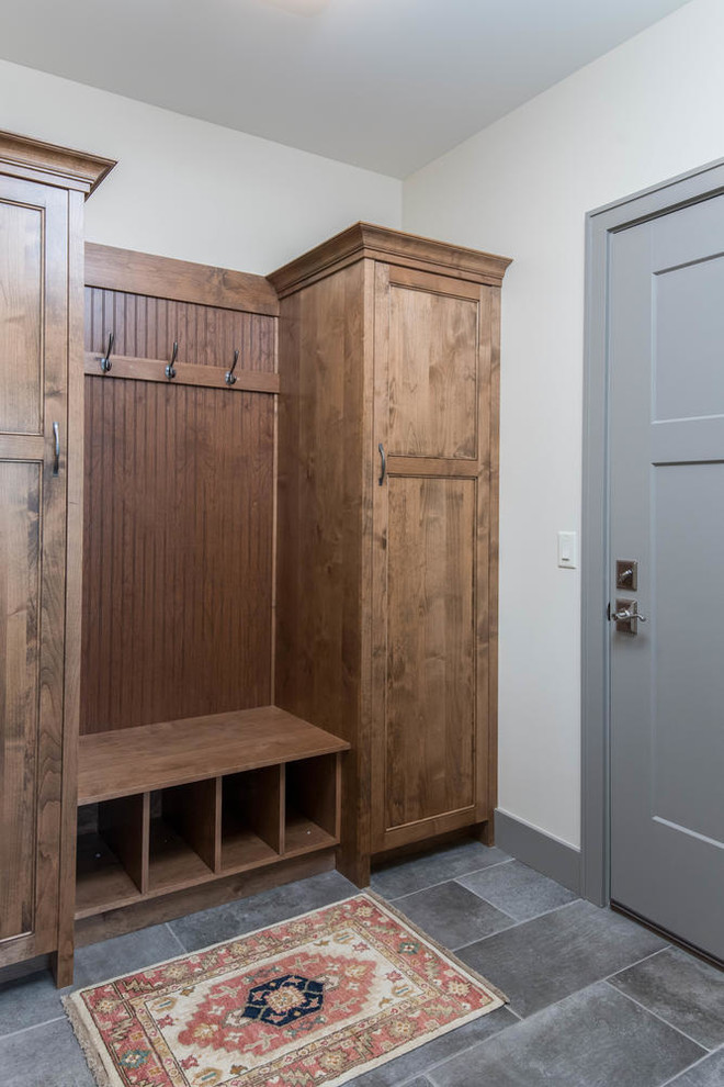 Example of a mid-sized transitional slate floor and gray floor mudroom design with white walls and a gray front door