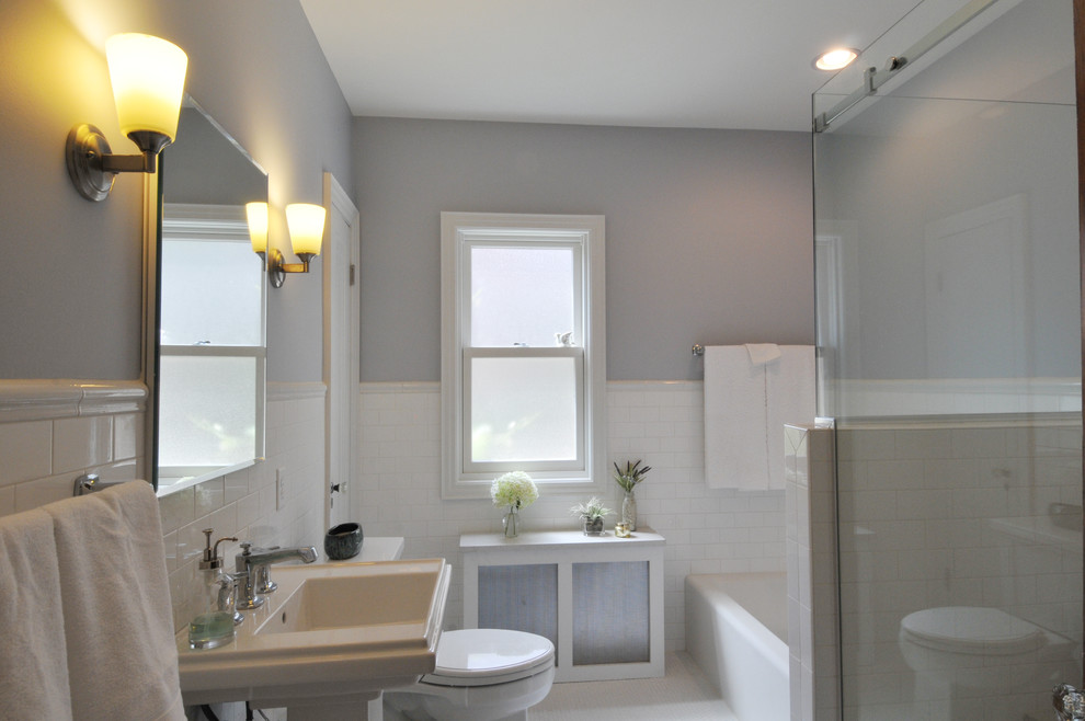 This is an example of a small eclectic kids bathroom in Milwaukee with a pedestal sink, an alcove tub, an alcove shower, a two-piece toilet, white tile, porcelain tile, grey walls and porcelain floors.