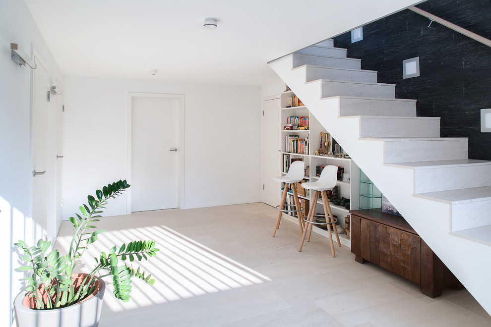 This is an example of a large contemporary hallway in Stuttgart with white walls and beige floor.
