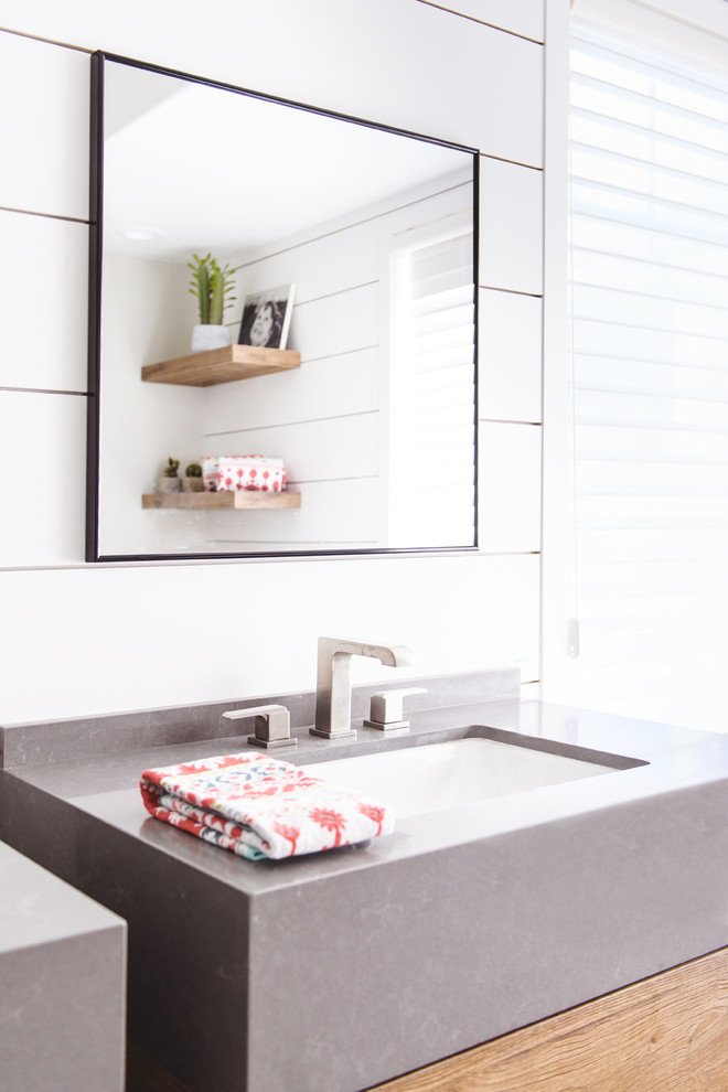 Inspiration for a mid-sized modern master bathroom in San Diego with flat-panel cabinets, medium wood cabinets, a freestanding tub, an alcove shower, blue tile, white tile, cement tile, white walls, an undermount sink, grey floor and an open shower.