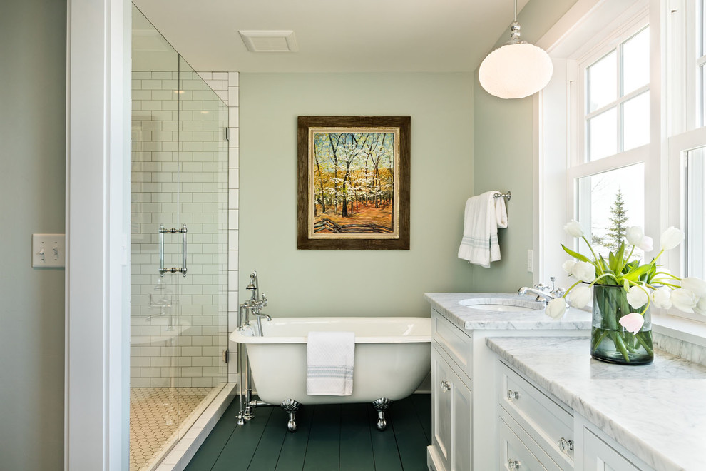 Photo of a mid-sized traditional master bathroom in Milwaukee with recessed-panel cabinets, white cabinets, a claw-foot tub, an alcove shower, white tile, subway tile, an undermount sink, green floor, a hinged shower door, green walls, painted wood floors, marble benchtops and white benchtops.