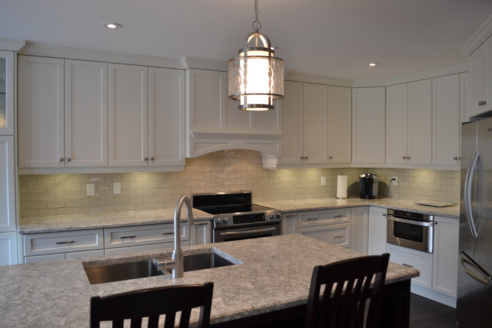 Example of a mid-sized transitional single-wall dark wood floor open concept kitchen design in Toronto with a double-bowl sink, recessed-panel cabinets, white cabinets, quartz countertops, gray backsplash, porcelain backsplash, stainless steel appliances and an island