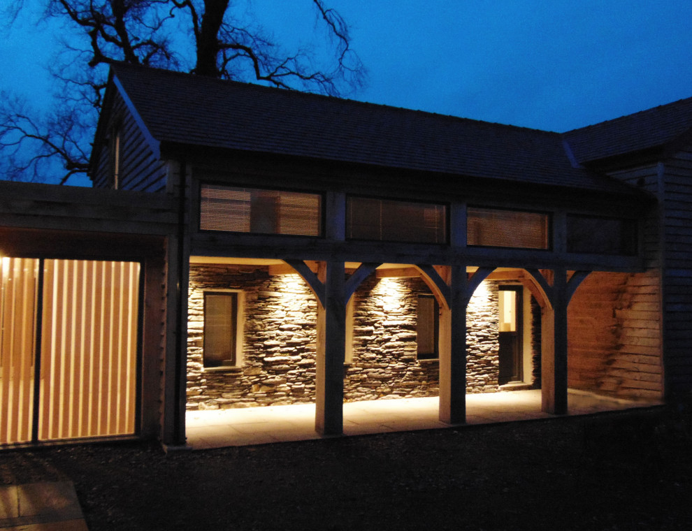 Photo of an expansive country two-storey white house exterior with wood siding, a gable roof and a tile roof.