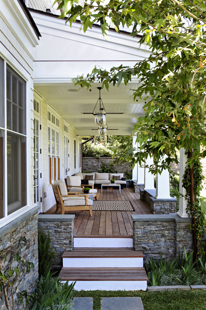 Elegant porch photo in Los Angeles with decking and a roof extension