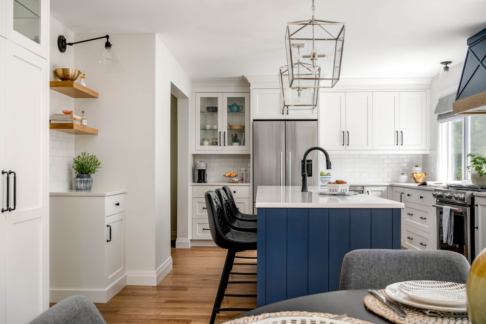 Inspiration for a large transitional l-shaped kitchen remodel in Toronto with shaker cabinets and an island