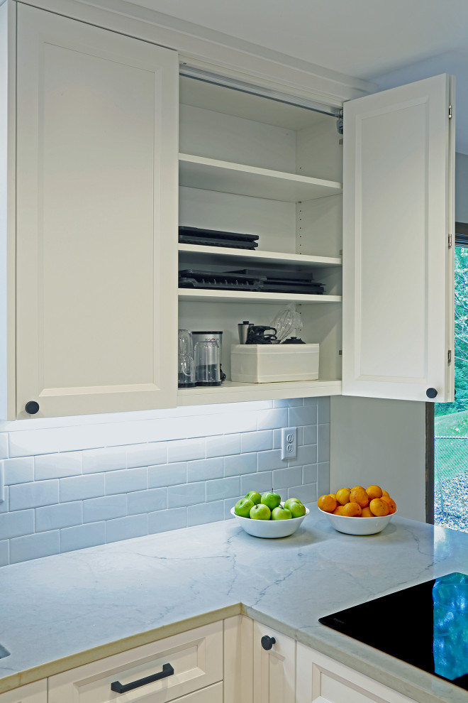 Example of a transitional u-shaped eat-in kitchen design in Minneapolis with recessed-panel cabinets, white cabinets, quartz countertops, white backsplash, no island, white countertops, subway tile backsplash and black appliances