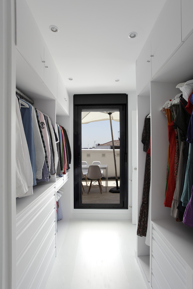 Photo of a contemporary walk-in wardrobe in Madrid.