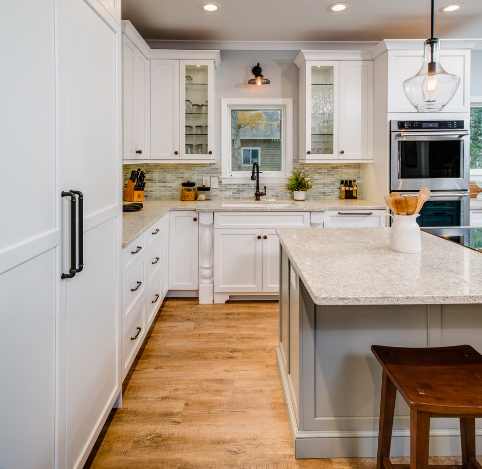 Mid-sized transitional medium tone wood floor and multicolored floor eat-in kitchen photo with an undermount sink, shaker cabinets, gray cabinets, quartz countertops, blue backsplash, mosaic tile backsplash, stainless steel appliances, an island and multicolored countertops