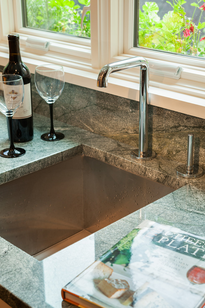 Open concept kitchen - large transitional galley medium tone wood floor open concept kitchen idea in Boston with an undermount sink, shaker cabinets, white cabinets, granite countertops, multicolored backsplash, stone slab backsplash, stainless steel appliances and a peninsula