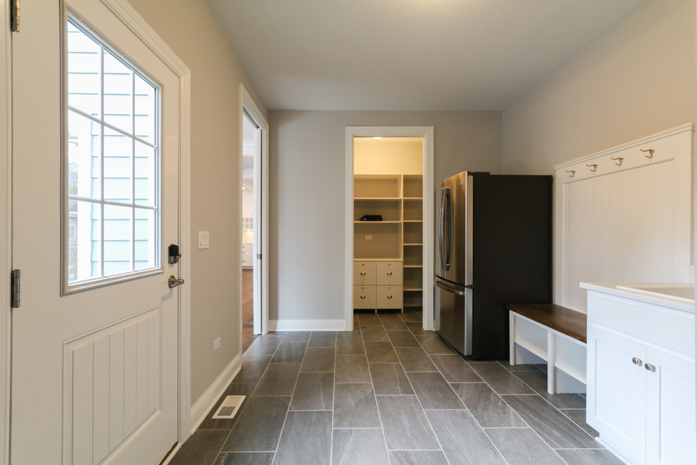 Design ideas for a large contemporary utility room in Chicago with a drop-in sink, ceramic floors, a side-by-side washer and dryer and grey floor.