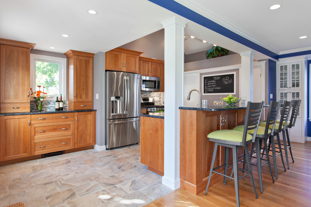 Elegant galley kitchen photo in Boston with shaker cabinets, medium tone wood cabinets, multicolored backsplash, matchstick tile backsplash and stainless steel appliances