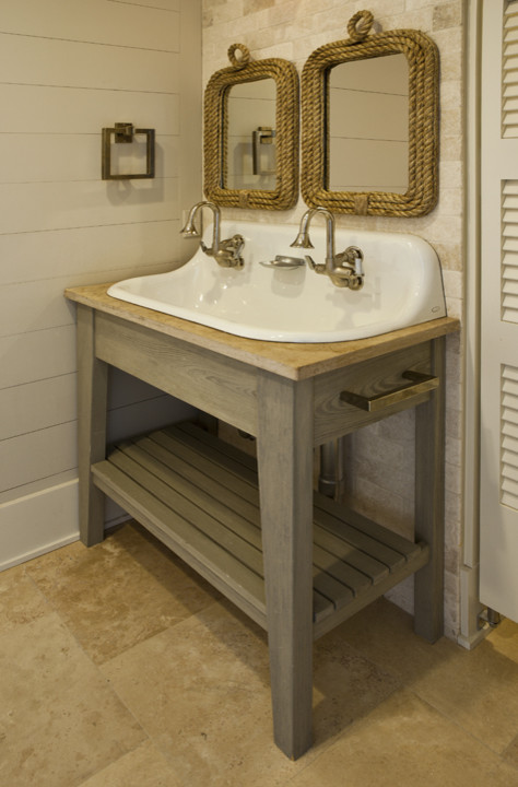 Inspiration for a mid-sized tropical 3/4 bathroom in Charleston with open cabinets, a two-piece toilet, beige walls, travertine floors, a trough sink, wood benchtops, light wood cabinets and beige benchtops.